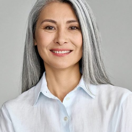 vertical-portrait-of-mature-50-years-asian-business-woman-on-grey-background--e1623738911734.jpg